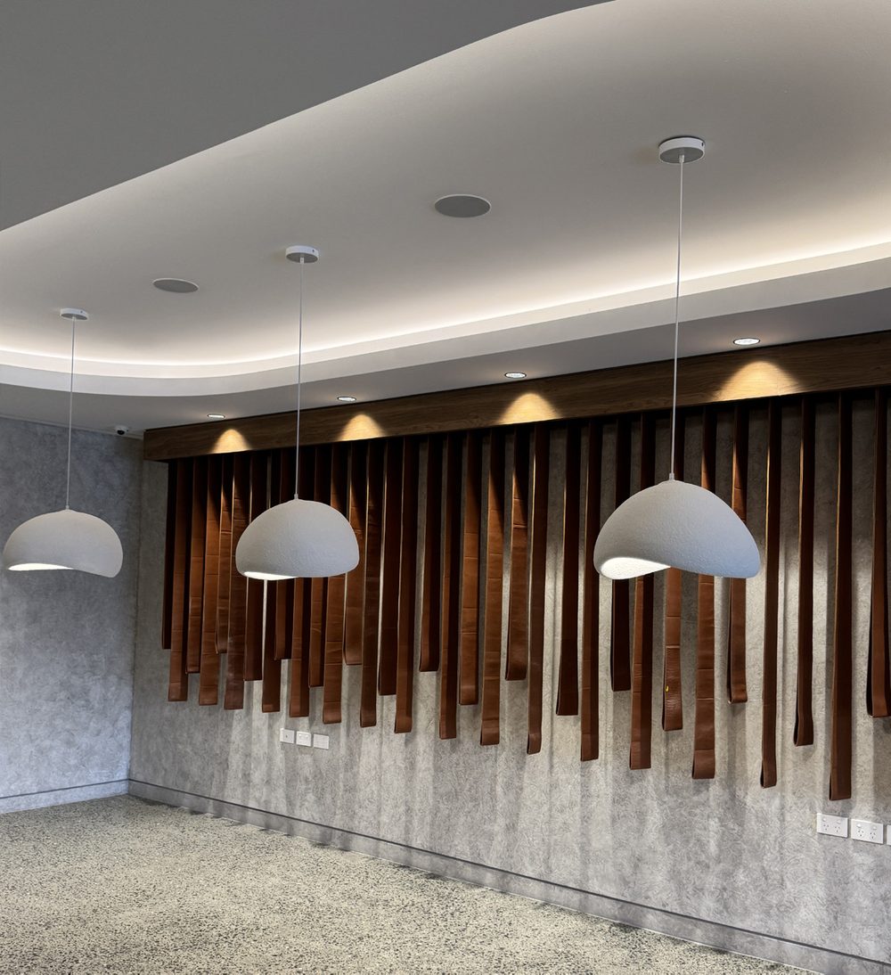 Completed Monado project — interior feature wall with pendant lighting
